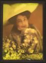 [Woman wearing fur jacket and large hat]