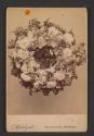[Still life with floral wreath]