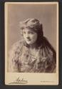 [Woman with long hair]