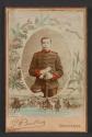 [Man in uniform holding sword]
