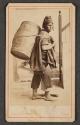 [Peruvian man carrying barrel]