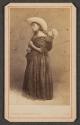 [Peruvian woman carrying child on her back]