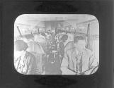 [Passengers in cabin of airplane]