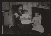 [Mother with two daughters in tenement]