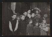 [Tenement family lined up for the visiting nurse]