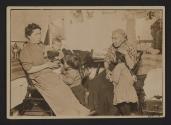[Mother, grandmother, and three children in tenement]