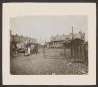[Group standing in shantytown]