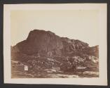 [Wooden structures at base of cliffs]