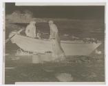 [Fishermen's beach -a woman and a child looking at a fisherman working]