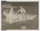 [Fishermen's beach - a woman,  three children and a fisherman around a boat]