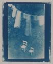 [Untitled (clothesline and two chairs in backyard)]