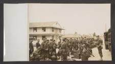 [American soldiers with their gear, waiting to board transportation]