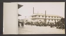 [American soldiers with their gear, waiting to board transportation]