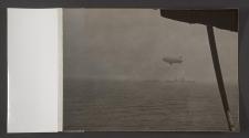 [US Navy K-class airship, a Brooklyn class light cruiser and a destroyer escorting a convoy crossing the Atlantic Ocean]