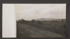 [Unpaved country road over looking fields and hills]