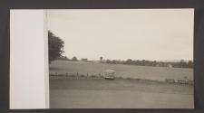 [Car with Belfast plates parked beside field]