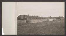 [Quonset huts and sandbag walls]