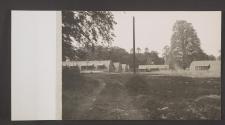 [Quonset huts in a wooded area]