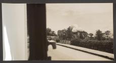 [Barrage balloon on tether near roadside.]