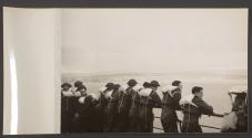 [British soldiers wearing flotation devices on the deck of a ship.]