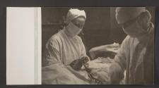 [Doctor and nurse operating on a patient]