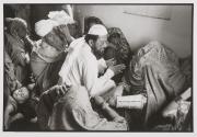 The local Maulvi in Hathma conducting a wedding ceremony. The bride is on the right and he is posing the question - will she give consent to marry this boy?