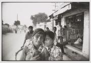 Geeta and Bimla waiting outside a local shop for their wheat to be ground, Bikaner.