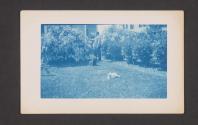 [Man with dog & cat in yard]