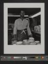 [Woman with saucers, Buffalo China, Buffalo, New York