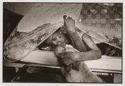 An HIV+ patient enjoys some comfort from one of Wat Prabat Nampu's many dogs