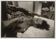 A Western volunteer comforts an HIV+ patient, who craves to be touched