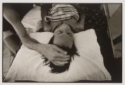 A Western volunteer gives much needed comfort to an HIV+ patient at Wat Prabat Nampu