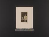 [Man and woman in formal wear; woman seated]