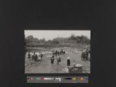 [People and ducks in rural village]