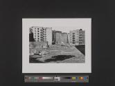 [Apartment buildings beyond Kingdom Hall of Jehovah's Witnesses building and debris]