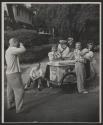 [Teen boy photographs his friends at an ice cream cart]