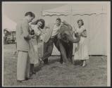 [Four teenagers taking pictures with Rahnee, a circus elephant]
