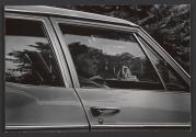 [Profile of woman through a car window]