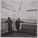 [Dr. Luigi DeAngelis (left), physician, with another man on a ferry between Sicily and Reggio Calabria]