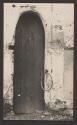 [Wooden door with iron ring]