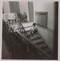 [Antonio Toscano, child of the photographer, seated in a stairwell]