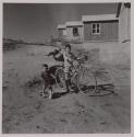 [Giuseppe and Antonio Toscano, children of the photographer, playing on bicycles]