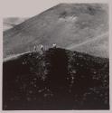 [Man and two children on hill]
