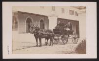 [Three people in horse-drawn carriage]