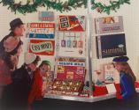 [People viewing a window display of Milton Bradley Co. games]