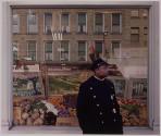 [Policeman by grocery store window]