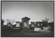Erna awaiting customers to tricks among the graves in the Kembang Kunung Christian cemetery located in Surabaya, Indonesia