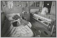 Too weak to pull himself, an AIDS patient breaks down and cries after falling while trying to get back to his bed at  the Wat Prah Bat Nam Phu hospice