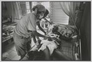 Volunteers rush to bedside of a man who just died from an AIDS related illness at the Wat Prah Bat Nam Phu hospice