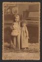 [Two children with doll]